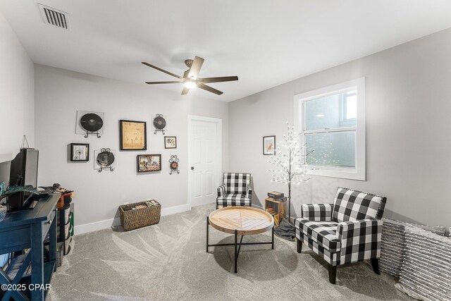 sitting room featuring ceiling fan and carpet flooring