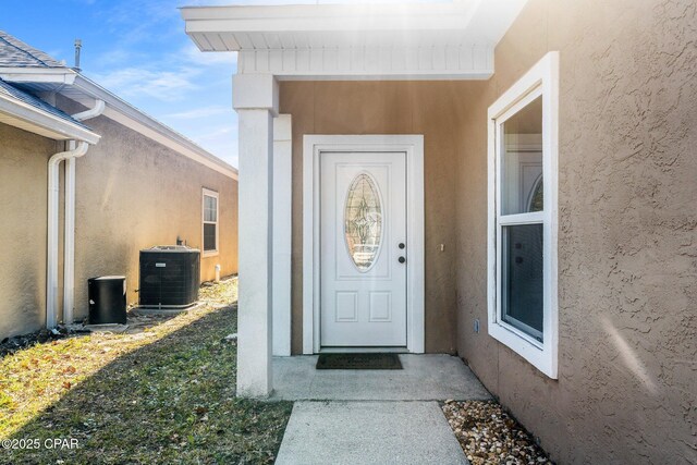 doorway to property with central AC unit