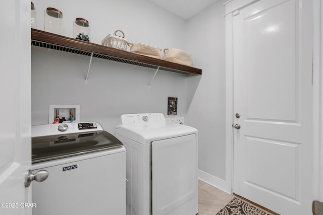 laundry room featuring separate washer and dryer and light tile patterned floors