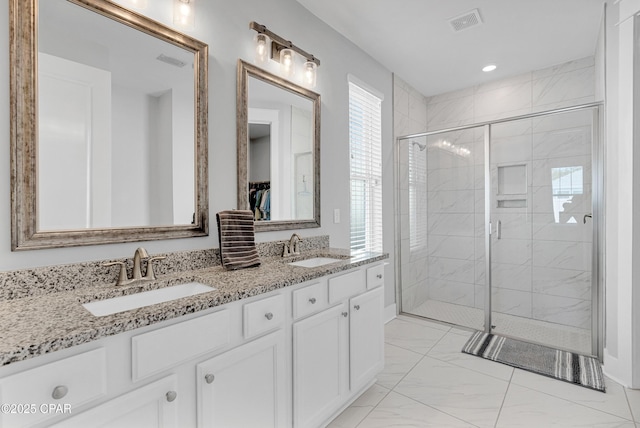 bathroom featuring walk in shower and vanity