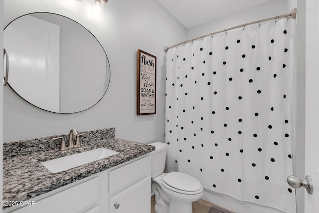 bathroom featuring toilet, vanity, and a shower with shower curtain