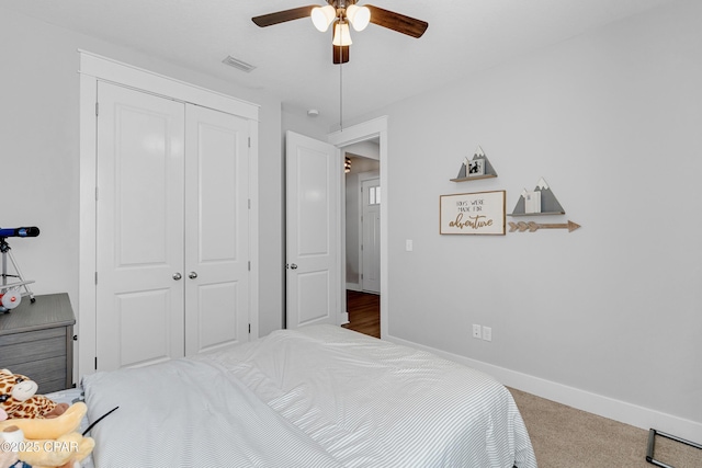 bedroom with ceiling fan, a closet, and carpet