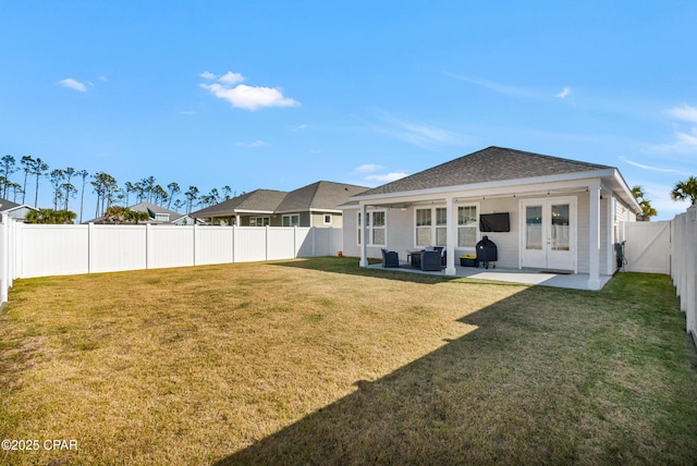 back of property with a lawn, french doors, outdoor lounge area, and a patio