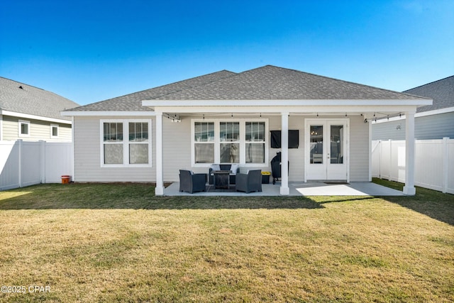 back of property featuring french doors, a patio area, and a yard