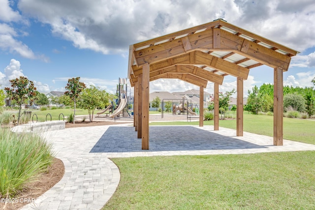 view of home's community featuring a yard and a playground