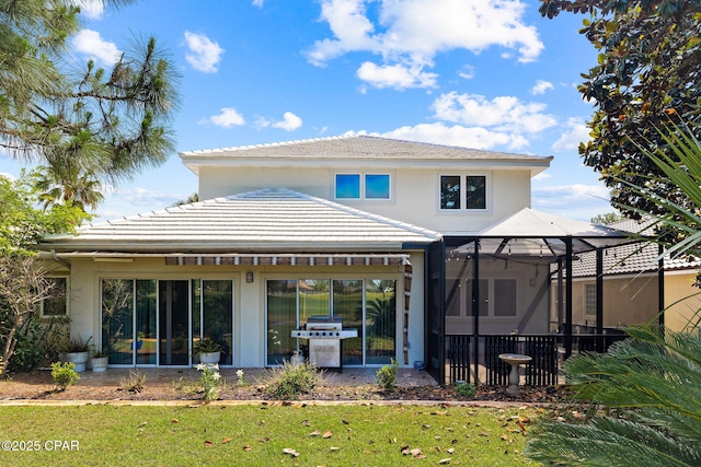 rear view of house featuring a lawn and a lanai