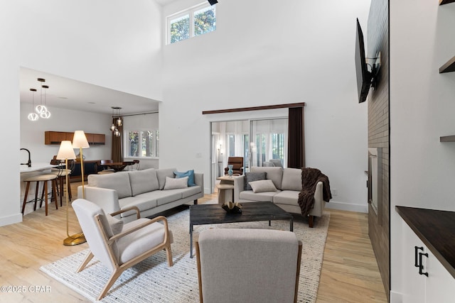 living room featuring a high ceiling and light hardwood / wood-style floors