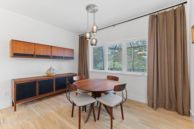 dining space with light wood-type flooring