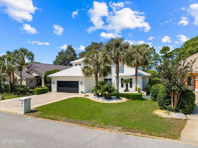 view of front of house with a garage and a front lawn