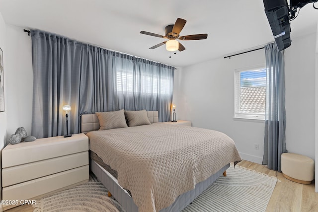 bedroom with light hardwood / wood-style flooring and ceiling fan