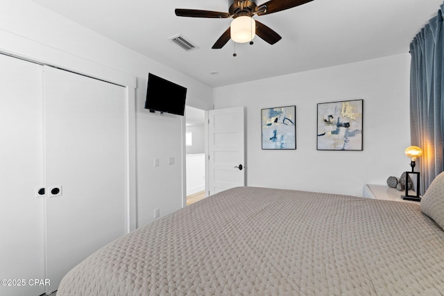 bedroom featuring ceiling fan and a closet