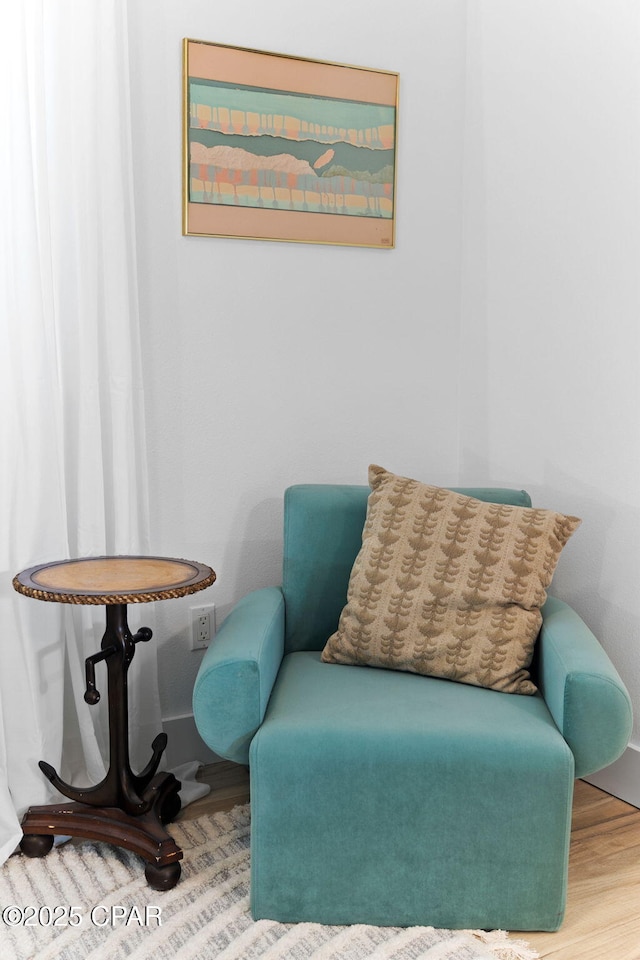 sitting room with wood-type flooring