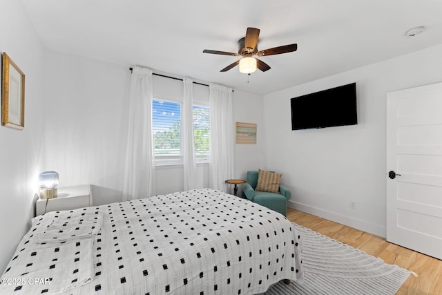 bedroom with ceiling fan and hardwood / wood-style flooring