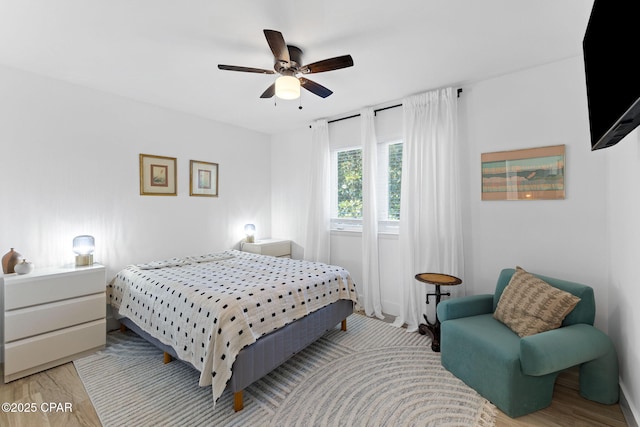 bedroom with light wood-type flooring and ceiling fan