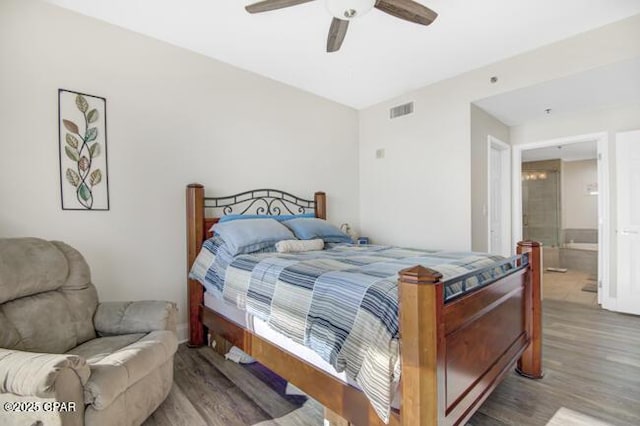 bedroom featuring ceiling fan, ensuite bathroom, and wood-type flooring