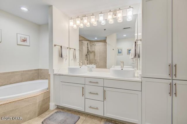 bathroom with tile patterned floors, vanity, and independent shower and bath