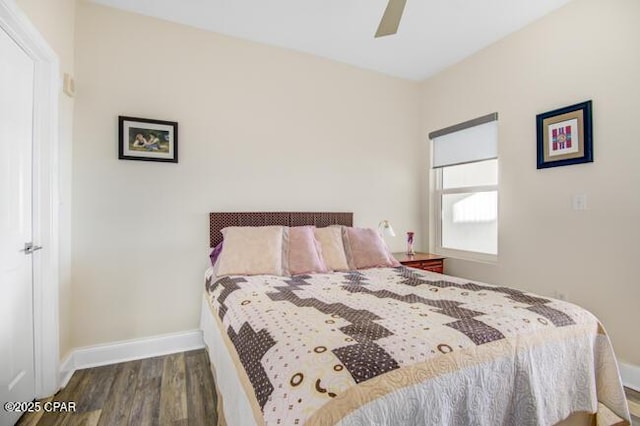 bedroom with ceiling fan and dark hardwood / wood-style flooring