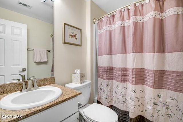 full bathroom featuring shower / bath combo, vanity, and toilet