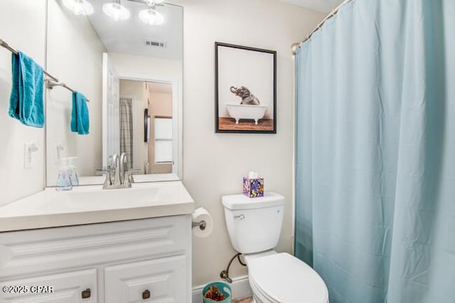 bathroom with vanity, toilet, and walk in shower