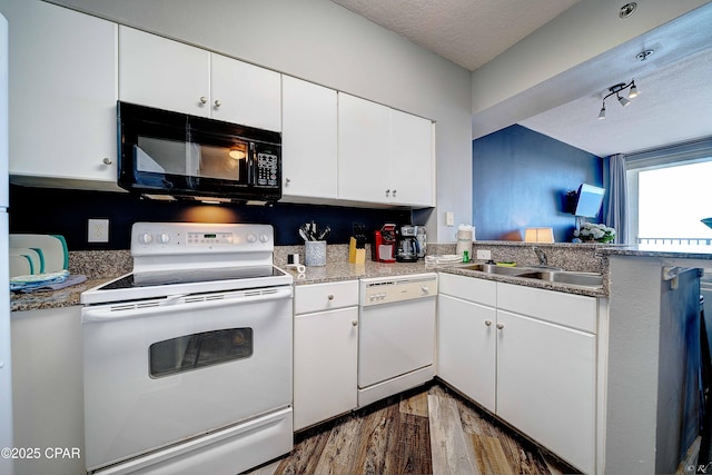 kitchen featuring white appliances, sink, white cabinets, and a textured ceiling