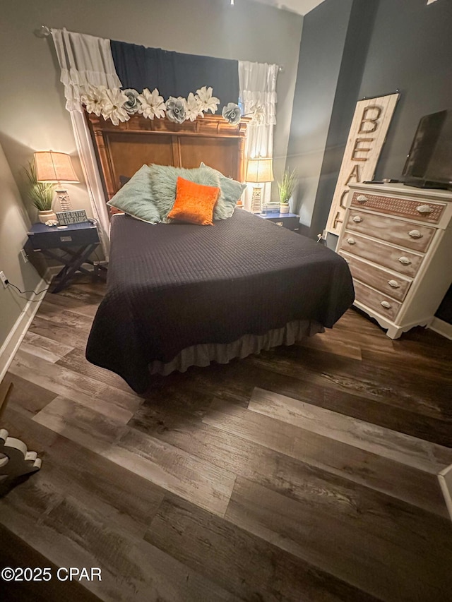 bedroom with wood-type flooring