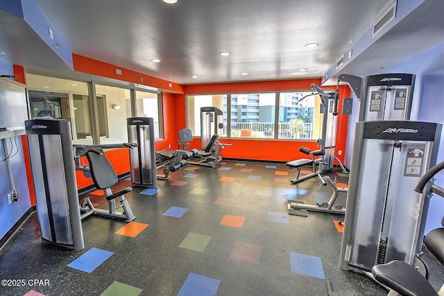 gym featuring a textured ceiling