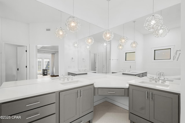 bathroom with visible vents, two vanities, and a sink