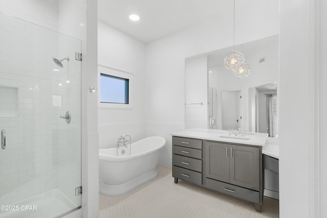 full bath featuring vanity, a freestanding bath, tile walls, and a shower stall