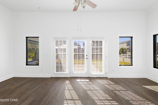 interior space featuring a healthy amount of sunlight, crown molding, and wood finished floors