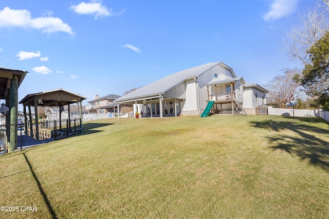 view of yard with a playground and fence