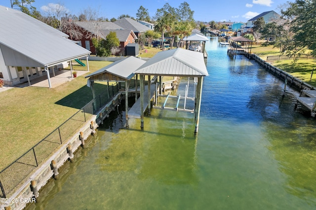 view of dock featuring boat lift, a residential view, a yard, and a water view