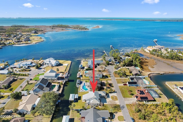 drone / aerial view with a water view and a residential view