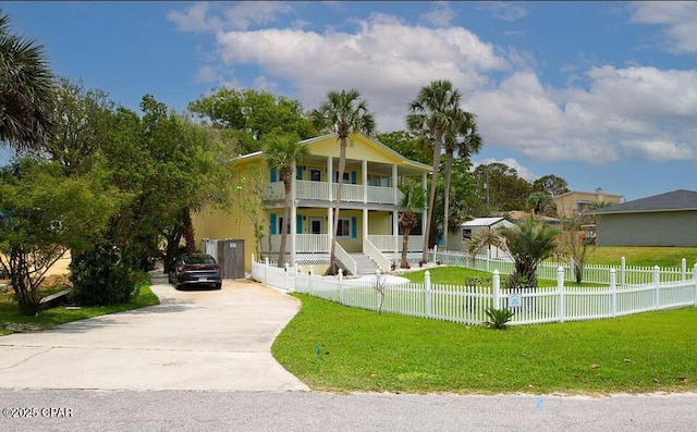 view of front of property featuring a porch, a balcony, and a front yard