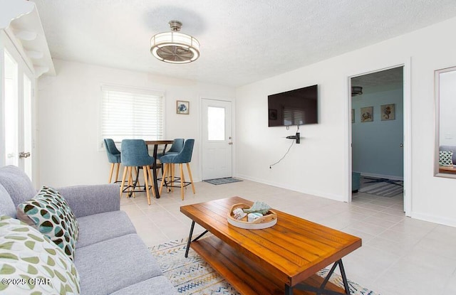 tiled living room with a textured ceiling