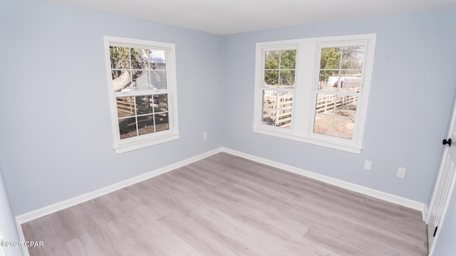 unfurnished room with light hardwood / wood-style flooring and a healthy amount of sunlight