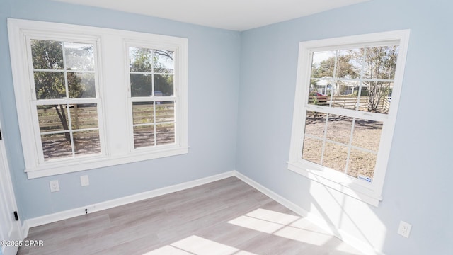 unfurnished room featuring hardwood / wood-style flooring