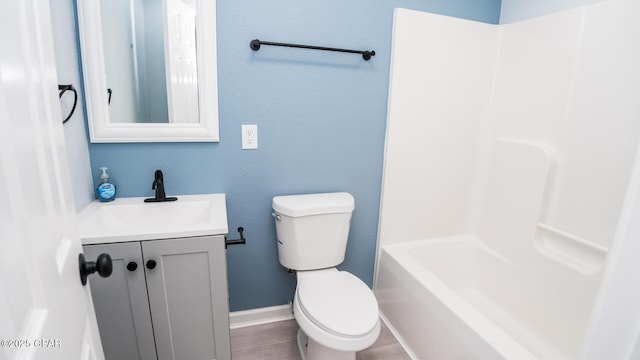 full bathroom with vanity, hardwood / wood-style floors, shower / bathtub combination, and toilet