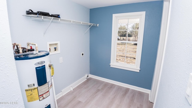 clothes washing area with hookup for a washing machine, light wood-type flooring, water heater, and hookup for an electric dryer