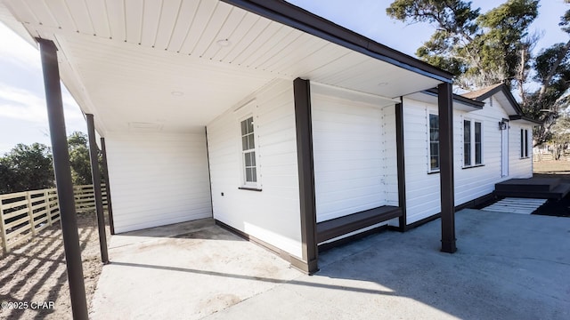 view of side of home with a carport