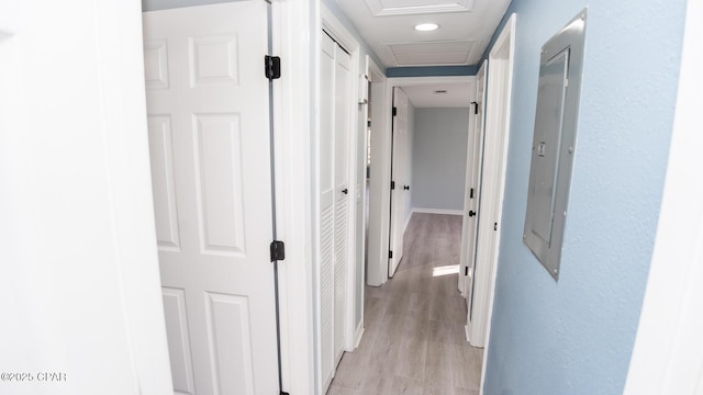 hallway with light hardwood / wood-style floors