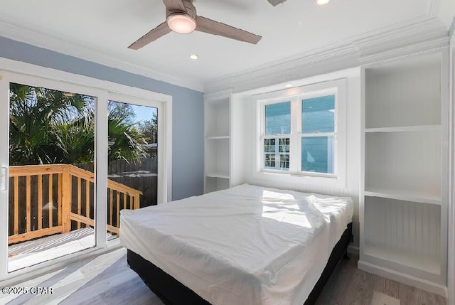 bedroom with ceiling fan, crown molding, and hardwood / wood-style floors