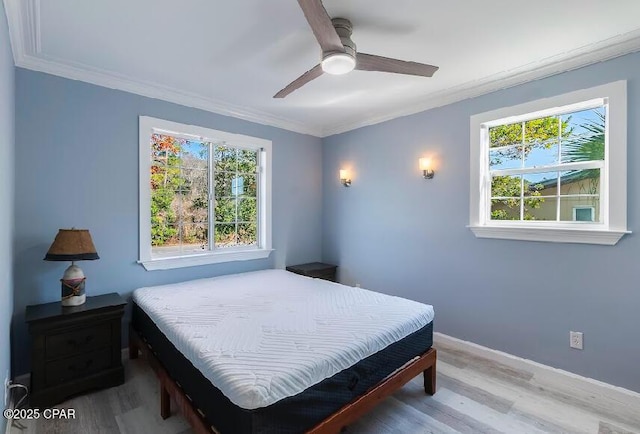 bedroom featuring ceiling fan, ornamental molding, and hardwood / wood-style floors