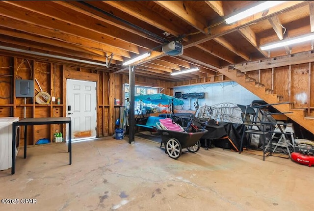 garage featuring a garage door opener and electric panel