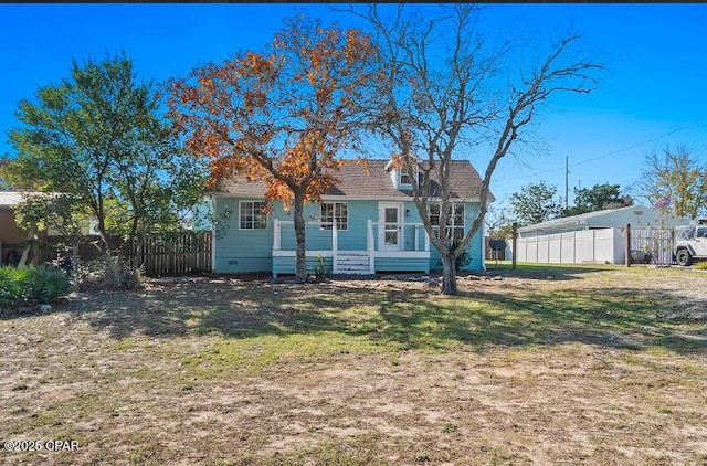 back of house with a lawn