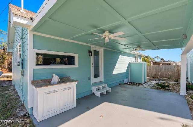 view of patio featuring ceiling fan