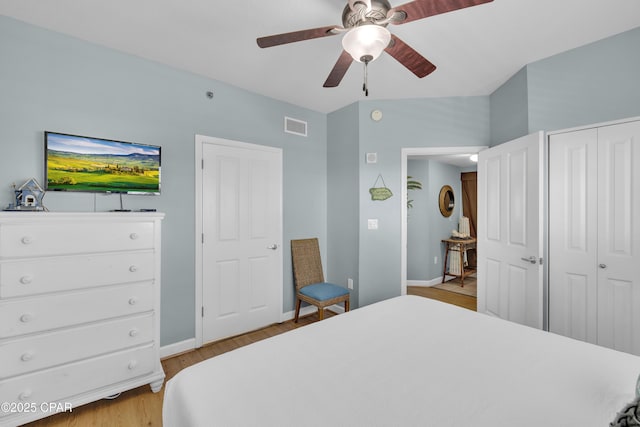 bedroom featuring ceiling fan, a closet, and light hardwood / wood-style flooring