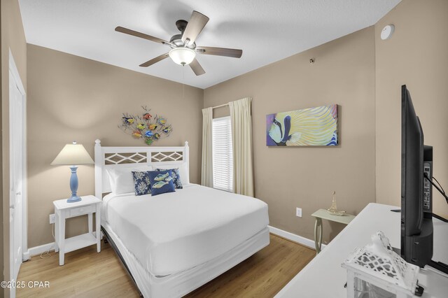 bedroom featuring ceiling fan and light hardwood / wood-style floors