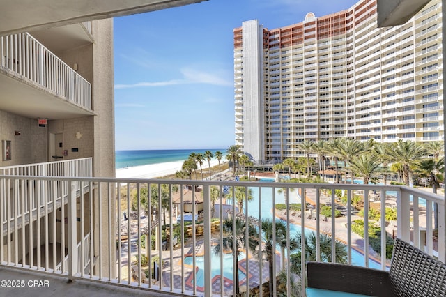 balcony with a beach view and a water view