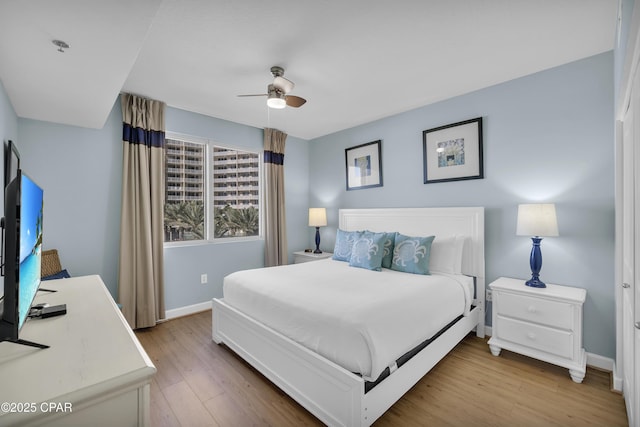 bedroom with wood-type flooring and ceiling fan