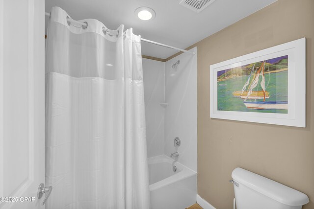 bathroom with shower / bath combo with shower curtain and toilet